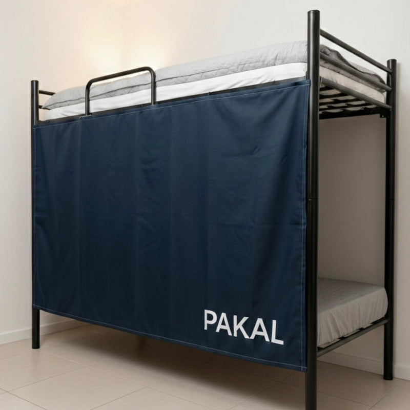 Bunk bed with a navy blue curtain labeled 'PAKAL' in a room.