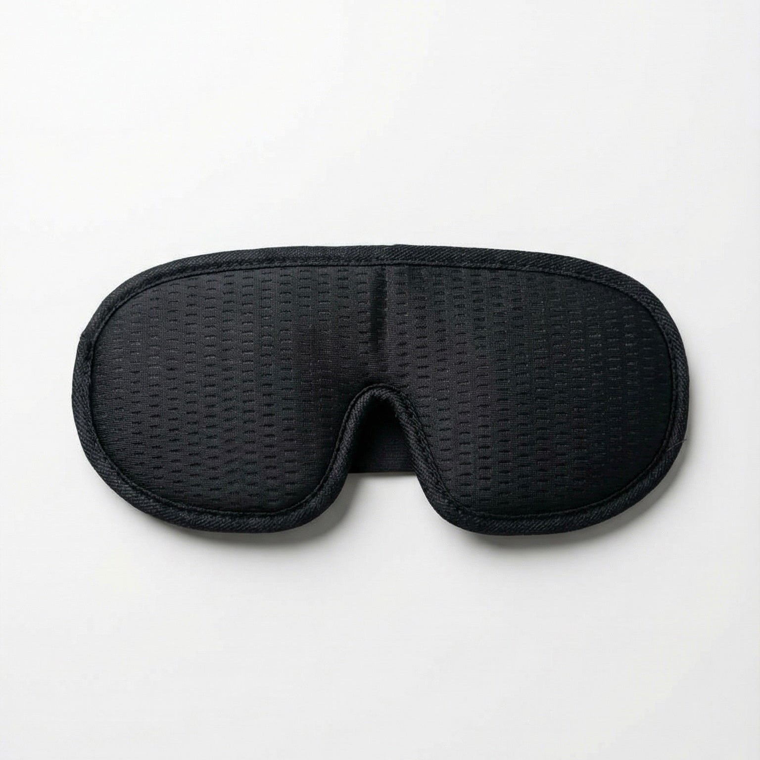 Black woven eye mask on a white background