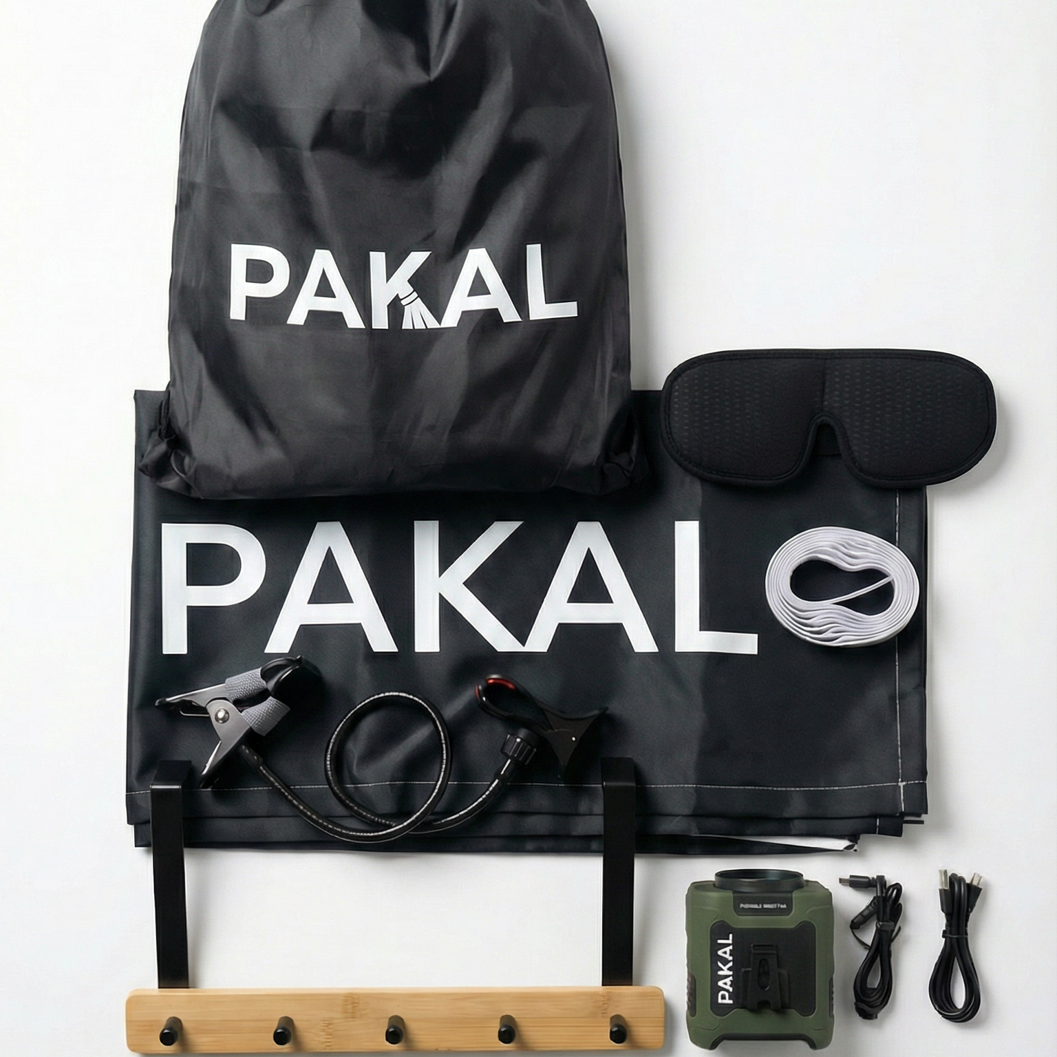 Pakal travel kit with black bag, sleep mask, earplugs, and other travel accessories on a white background.